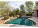 Serene backyard pool with rock waterfall feature and desert landscaping at 9626 E Peak View Rd, Scottsdale, AZ 85262