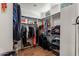 Spacious walk-in closet with ample storage space, including shelves, hanging rods, and luggage racks at 9626 E Peak View Rd, Scottsdale, AZ 85262