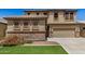 Charming two-story home featuring a neutral color scheme, stone accents, and a well-maintained lawn at 11728 W Villa Hermosa N Ln, Sun City, AZ 85373