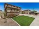 Two-story home with a 2-car garage, stone accents, and neat front lawn at 11728 W Villa Hermosa N Ln, Sun City, AZ 85373