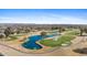 Scenic aerial of a vibrant golf course with a serene pond, sand traps, and rolling fairways at 12814 W Shadow Hills Dr, Sun City West, AZ 85375
