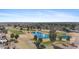 Breathtaking aerial view showcasing a golf course with mature trees and luxurious ponds at 12814 W Shadow Hills Dr, Sun City West, AZ 85375