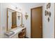 Bathroom with a large mirror, well-lit vanity, and decorative accents on the walls at 12814 W Shadow Hills Dr, Sun City West, AZ 85375