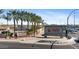 Entrance sign to Sun City West is framed by lush palm trees, flowers, and clear signage for community recognition at 12814 W Shadow Hills Dr, Sun City West, AZ 85375