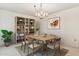 Elegant dining room with a wooden table, stylish chandelier, and chic decor for sophisticated gatherings at 12814 W Shadow Hills Dr, Sun City West, AZ 85375