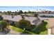 Aerial view highlighting the house, landscaping, and outdoor living spaces with mature trees and desert flora at 12814 W Shadow Hills Dr, Sun City West, AZ 85375