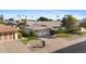 Well-manicured front yard with a two-car garage, mature landscaping, and an inviting curb appeal at 12814 W Shadow Hills Dr, Sun City West, AZ 85375