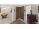 Foyer features neutral tile flooring, double doors, and vintage accents at 12814 W Shadow Hills Dr, Sun City West, AZ 85375