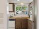 Well-lit kitchen with functional layout, vintage appliances, and view to outside for comfortable meal preparation at 12814 W Shadow Hills Dr, Sun City West, AZ 85375