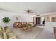 Cozy living room with a comfortable brown sofa, inviting decor, and ample natural light for relaxation at 12814 W Shadow Hills Dr, Sun City West, AZ 85375