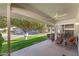 Inviting covered patio with wicker seating, perfect for enjoying the serene backyard views and relaxing outdoors at 12814 W Shadow Hills Dr, Sun City West, AZ 85375