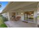 Charming patio features wicker furniture, ceiling fan, and easy access to the outdoors through sliding glass doors at 12814 W Shadow Hills Dr, Sun City West, AZ 85375