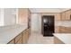 Traditional kitchen featuring tile floors, neutral countertops, and a full suite of appliances at 14158 W Desert Glen Dr, Sun City West, AZ 85375