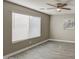 Bedroom with a ceiling fan, large window with blinds, and neutral paint colors at 14334 N 129Th Ave, El Mirage, AZ 85335