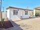 Charming exterior with white siding, brick base, gravel and cactus landscaping in an Arizona backyard at 1541 W Culver St, Phoenix, AZ 85007