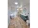 Updated bathroom with a soaking tub, glass shower with tile accents and a blue vanity with double sinks at 1541 W Culver St, Phoenix, AZ 85007