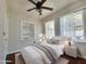 Cozy bedroom with a plush bed, decorative shelving, and bright natural light at 1541 W Culver St, Phoenix, AZ 85007