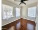 Inviting bedroom boasting gleaming hardwood floors and sheer curtains on bright windows at 1541 W Culver St, Phoenix, AZ 85007