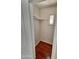 A compact storage area with a wooden floor and a small window provides natural light at 1541 W Culver St, Phoenix, AZ 85007