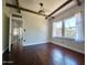 Empty room featuring hardwood floors, high ceilings with beams, and a window at 1541 W Culver St, Phoenix, AZ 85007