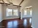 Empty room featuring hardwood floors, high ceilings with beams, and large windows at 1541 W Culver St, Phoenix, AZ 85007