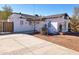 Exterior of a white home with a concrete driveway and a well-maintained landscape at 1541 W Culver St, Phoenix, AZ 85007