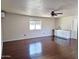 A roomy living area features hardwood flooring, a ceiling fan, and a built in bar at 1541 W Culver St, Phoenix, AZ 85007