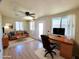 Bright living room featuring a ceiling fan, modern desk, and comfortable leather sofa at 1541 W Culver St, Phoenix, AZ 85007