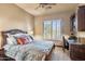 Bedroom features a decorative bedframe, ceiling fan, window with shutters, and a desk area at 15956 E Tombstone Trl, Fountain Hills, AZ 85268