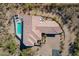 An aerial view of the home showcases a private pool, tile roof, desert landscaping, and brick paved driveway at 16141 E Thistle Dr, Fountain Hills, AZ 85268
