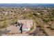 Aerial view of the home showing desert landscaping, tile roof, and a large multi-car driveway at 16141 E Thistle Dr, Fountain Hills, AZ 85268