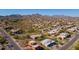 Aerial view of a suburban neighborhood showcasing custom homes with desert landscaping and a mountain view at 16141 E Thistle Dr, Fountain Hills, AZ 85268