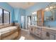 Bright bathroom with a large soaking tub and natural light from the picture window and double sink vanity at 16141 E Thistle Dr, Fountain Hills, AZ 85268