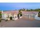 Beautiful desert home featuring a three-car garage and a spacious brick driveway at 16141 E Thistle Dr, Fountain Hills, AZ 85268