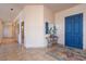 Inviting foyer with tile flooring, light walls, blue entry door, and a stylish console table at 16141 E Thistle Dr, Fountain Hills, AZ 85268
