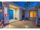 Front entrance features a cozy courtyard and a brightly-painted blue front door at 16141 E Thistle Dr, Fountain Hills, AZ 85268