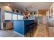 Bright kitchen with a blue island, granite counters, and ample cabinet space at 16141 E Thistle Dr, Fountain Hills, AZ 85268