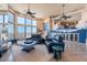 Open-concept living room with a fireplace, expansive windows, and mountain views at 16141 E Thistle Dr, Fountain Hills, AZ 85268