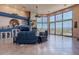Spacious living room featuring tile flooring, a cozy fireplace, and large windows showcasing mountain views at 16141 E Thistle Dr, Fountain Hills, AZ 85268
