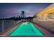 Beautiful backyard pool features updated white fencing, patio and desert landscaping at dusk at 16141 E Thistle Dr, Fountain Hills, AZ 85268