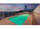Sparkling pool with night lighting and mountain views, surrounded by desert landscaping at 16141 E Thistle Dr, Fountain Hills, AZ 85268