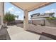 Spacious backyard with a covered patio, gravel landscaping, and privacy wall, perfect for outdoor entertaining at 20626 N 55Th Ave, Glendale, AZ 85308