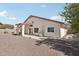 Back of home features a covered patio and gravel landscaping with a wall ensuring privacy at 20626 N 55Th Ave, Glendale, AZ 85308