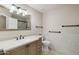 Neutral bathroom with a large mirror, black towel racks, toilet, and tiled flooring at 20626 N 55Th Ave, Glendale, AZ 85308