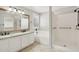Bathroom features a double sink vanity with granite countertops, tub, and walk-in shower at 20626 N 55Th Ave, Glendale, AZ 85308