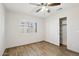 Bedroom with a window, ceiling fan, and closet featuring shelves for ample storage at 20626 N 55Th Ave, Glendale, AZ 85308