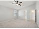 Bedroom showcasing neutral walls, carpet floors, a ceiling fan, and two doorways at 20626 N 55Th Ave, Glendale, AZ 85308