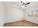 Bedroom featuring a ceiling fan, window, and light wood flooring throughout the room at 20626 N 55Th Ave, Glendale, AZ 85308