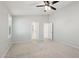 Bedroom boasts carpeted floors, neutral walls, a ceiling fan, and two open doorways at 20626 N 55Th Ave, Glendale, AZ 85308