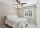 Cozy bedroom with plush bedding, ceiling fan, and window with bright, natural light at 20626 N 55Th Ave, Glendale, AZ 85308